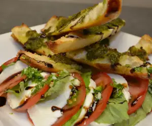 Caprese salad with fresh tomatoes, mozzarella, basil and balsamic.