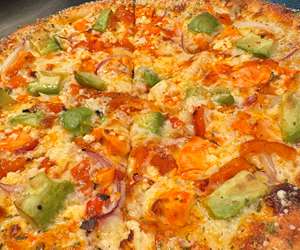 The “Morning Dew” specialty pizza: Buffalo tossed chicken, Avocado, Red pepper & Onion & Feta! 