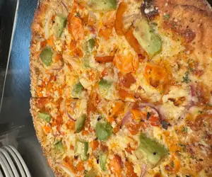 The “Morning Dew” specialty pizza: Buffalo tossed chicken, Avocado, Red pepper & Onion & Feta! 