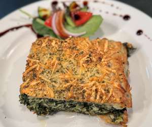 Spanakopita is our crispy buttered phyllo dough encasing spinach and feta 