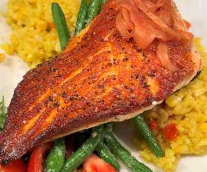 Seared salmon over a bed of rissotto and green beans