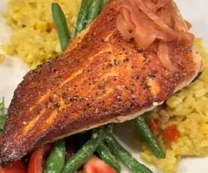 Seared salmon over a bed of rissotto and green beans