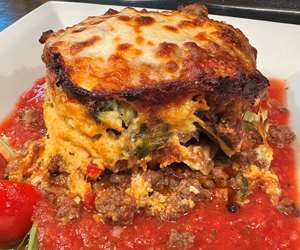Moussaka with fried eggplant layers, beef ragu covered with melted mozzarella 