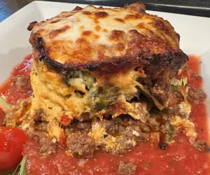 Moussaka with fried eggplant layers, beef ragu covered with melted mozzarella 