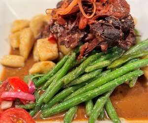 Braised beef on a bed of green beans and polenta gnocchi
