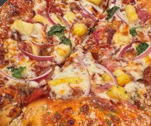 Our Hawaiian BBQ pizza: Bacon, Pineapple, Red Onion & Basil on BBQ 