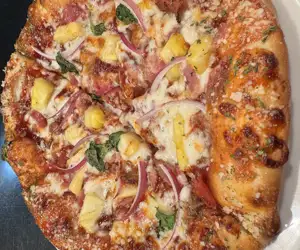 Our Hawaiian BBQ pizza: Bacon, Pineapple, Red Onion & Basil on BBQ 