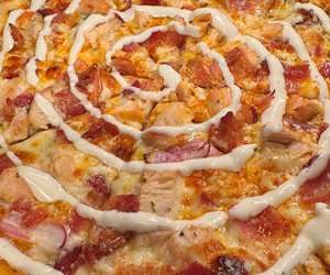 Our Buffalo “Chico” Pizza: Hot sauce base, Bacon, Chicken, Red onion & a sprinkle of Gorgonzola with a Ranch drizzle. 