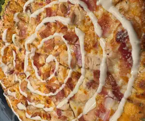 Our Buffalo “Chico” Pizza: Hot sauce base, Bacon, Chicken, Red onion & a sprinkle of Gorgonzola with a Ranch drizzle. 