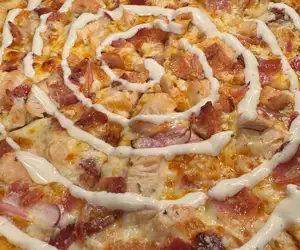 Buffalo Chico Pizza with chicken, red onion, bacon, gorgonzola, and buffalo sauce. 